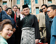 The son of Malaysian PM Abd Allah Badawi (C) is linked to allegation
