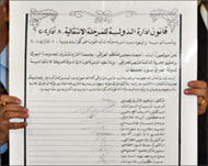 A member of the Governing council holds the signed document