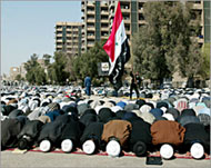 Iraqi Shia clerics lead Friday prayer on the street in Baghdad