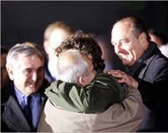 Chesnot (in green jacket) hugsal-Jundi in Paris on December 22