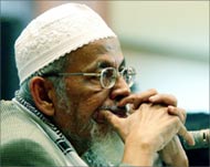 Abu Bakr Bashir sits in a courtroom during his trial 