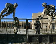 US soldiers secure a school due to be a polling station in Mosul