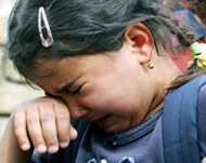 A girl cries after her home wasdestroyed by a car bomb  