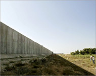 Palestinians herd sheep near Israel's wall near Qalqilya