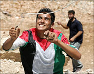 Palestinians in Bil'in throwingstones at Israeli border guards