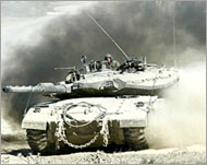 An Israeli army tank moves into the Gaza Strip on Saturday