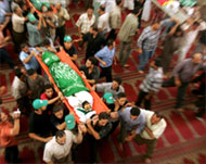 Mourners carry Hamas members'bodies at their funeral in Jabaliya