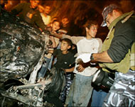 A Palestinian policeman checks the car of Majid Natat