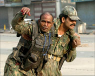 A woundedIndian soldier getshelp during the Srinagar gunfight 