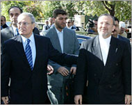 Mottaki (L) says the US is servingIsraeli interests in the region
