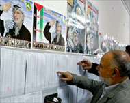 A Fatah member checks out the voters list 
