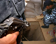 Palestinian policemen check a tunnel in May 2005 (File photo)