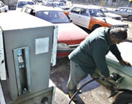 A man fills his car at a petrol station in Baghdad on Friday
