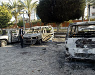 Cars set ablaze by rioters in frontof the parliament in Gaza city 