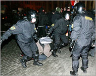 Riot policemen in Minsk arrestingan opposition activist on Friday