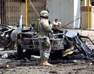 A US soldier secures the scene of a car bomb attack in Baghdad