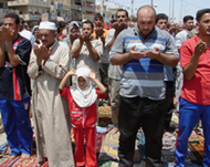 Shias perform the Friday noon prayer in Sadr City in Baghdad