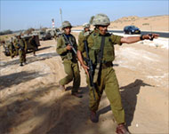 Israeli soldiers patrol the area near the border crossing 