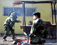 An Afghan bomb disposal expert (L) approaches a cart in Kabul
