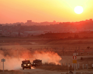 Israeli army jeeps patrol along the border in southern Israel