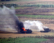 An Israeli tank burns after beinghit by a Hezbollah missile