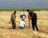 Hezbollah fighters inspect the site of the Israeli raid