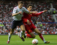 England's Steven Gerrard (L) vieswith Goran Maznov of Macedonia