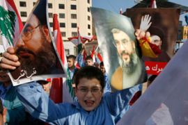 Schoolchildren hold up posters of Nasrallah in Beirut