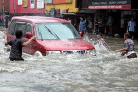 Indonesian boys play as a car drives through a flooded street in Jakarta Indonesia Thursday 01 February 2007.