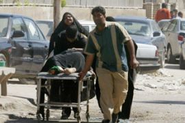 A woman who was wounded in a bomb blast is wheeled into a hospital in Baghdad March 11, 2007