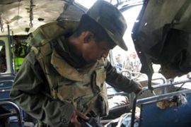 Sri Lankan soldier examines bus bombing