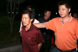 Heng Tinghan (L), accused of employing slave labourers