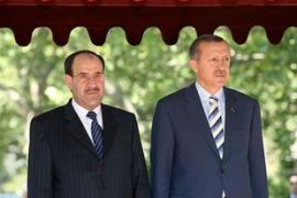 Iraqi Prime Minister Nuri al-Maliki (L) stands beside Turkish Prime Minister Recep Tayyip Erdogan