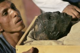 King Tutankhamun as he is removed from his stone sarcophagus