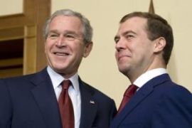 Former Russian President Dimitry Medvedev (R) and Former US President George W. Bush stand together during a bilateral meeting at the President's summer retreat Docharov Ruchei in Sochi, Russia. [File photo:AFP PHOTO/Jim WATSON]