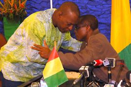 Guinean junta leader Captain Moussa Dadis Camara embraces new interim leader General Sekouba Konate