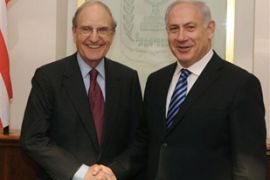 George Mitchell (L) shakes hands with Israeli Prime Minister Benjamin