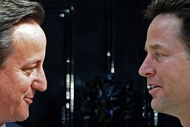 Prime Minister David Cameron (L) and new Deputy Prime Minister Nick Clegg