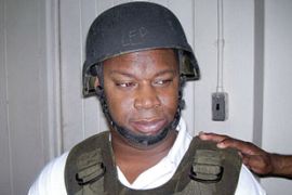 Handout photo of Christopher “Dudus” Coke wearing a helmet and a flak jacket