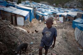 A boy stands amidst tents in Haiti