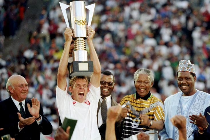 3 Feb 1996: Neil Touey of South Africa lifts the African nations Cup with Nelson Mandela on his right hand side after the African Nations Cup final match against Tunisia played in South Africa. The match finished in a 2-0 win for South Africa.  Mandatory Credit: Mark Thompson /Allsport