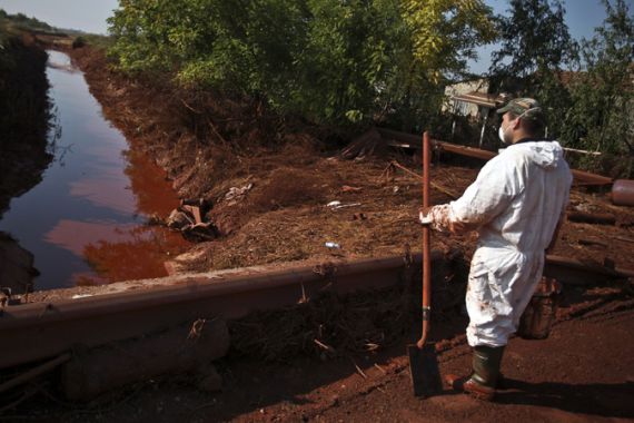 Worker clears up toxic sludge