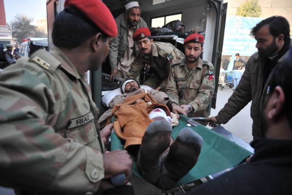 Pakistani army soldier shift an injured of a suicide bombing