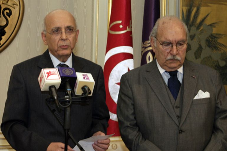 Tunisian Prime Minister Mohammed Ghannouchi (L) addresses the nation on state television, flanked by the President of the Tunisian Parliament Fouad Mbazaa