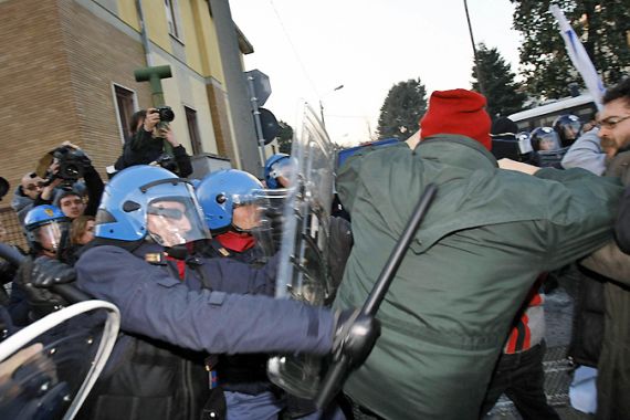Demonstrators fight with police during a protest against Italian Prime Minister Silvio Berlusconi in Arcore, near Milan