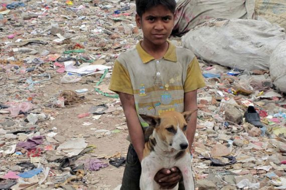 Bangladeshi street child with his dog