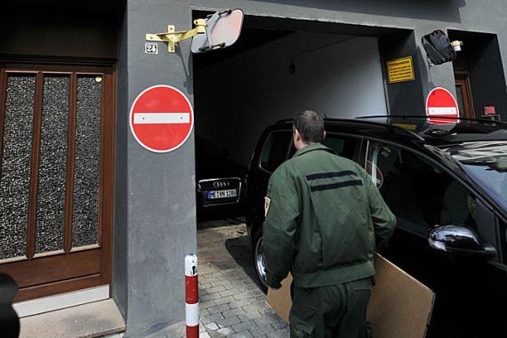 A police officer carries a box into a house of an alleged terrorist of Al-Qaeda in Duesseldorf, Germany