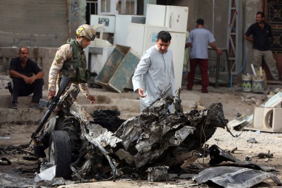 Iraq soldier inspects bomb damage in Baghdad