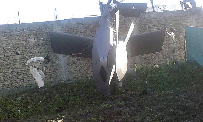 Part of a damaged helicopter is seen lying near the compound after U.S. Navy SEAL commandos killed al Qaeda leader Osama bin Laden in Abbottabad