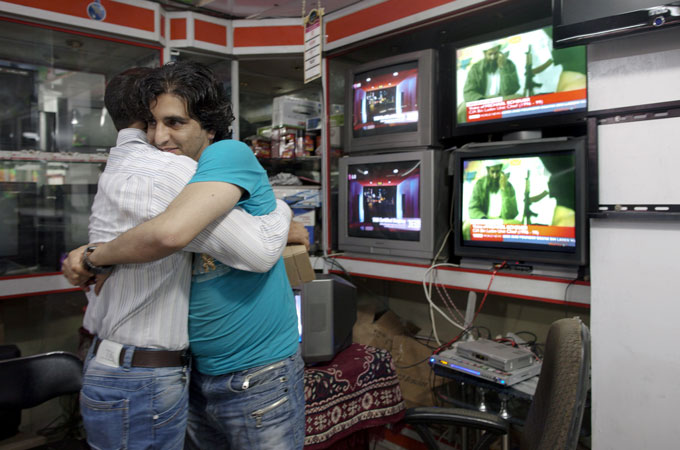 Afghan ben embrace after news of bin Laden death